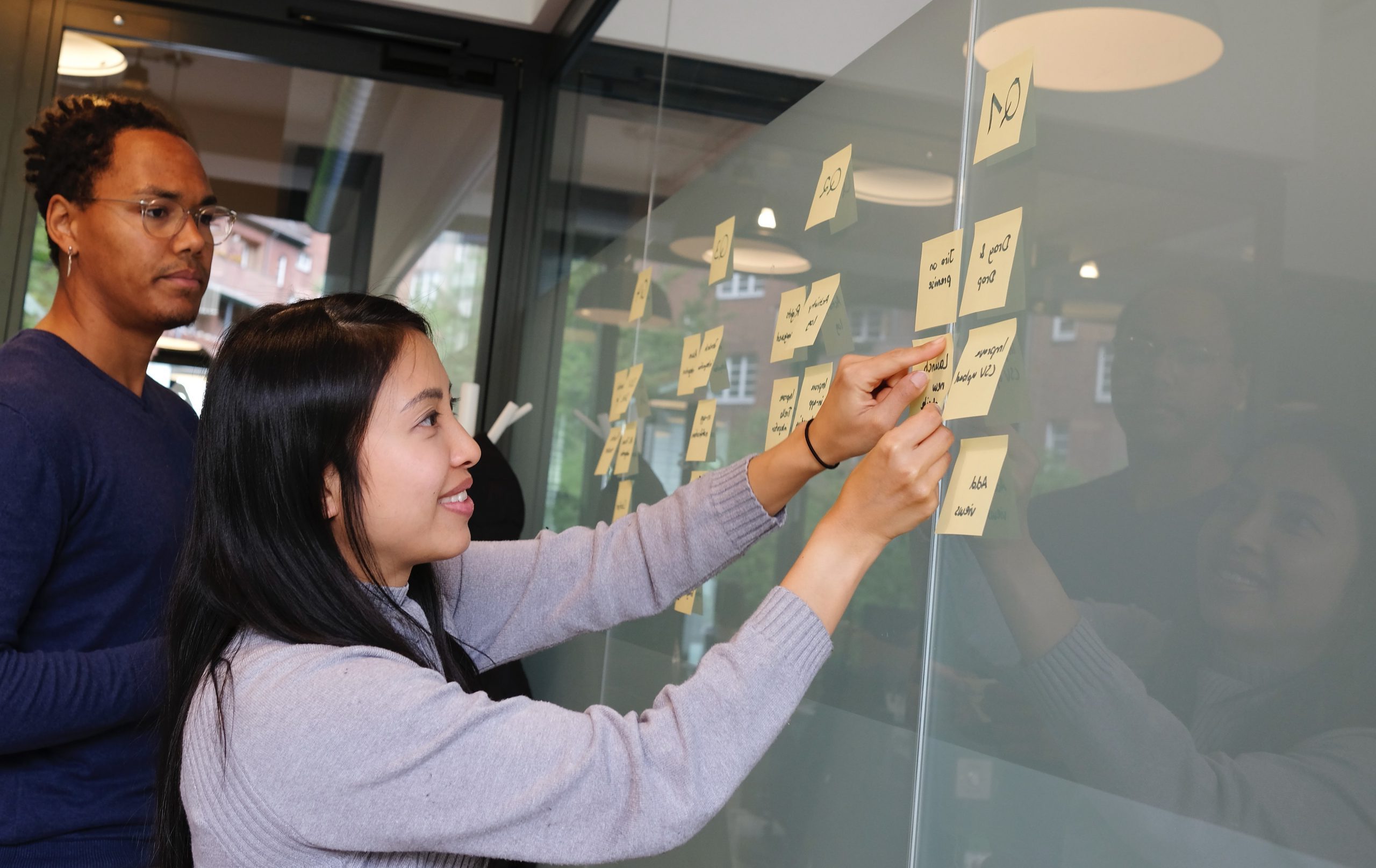 people working at board to solve a problem