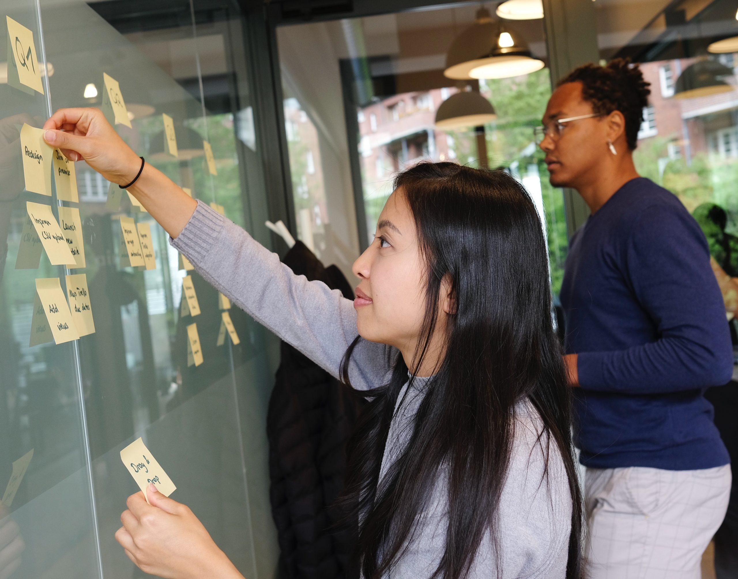 people working at board to solve a problem